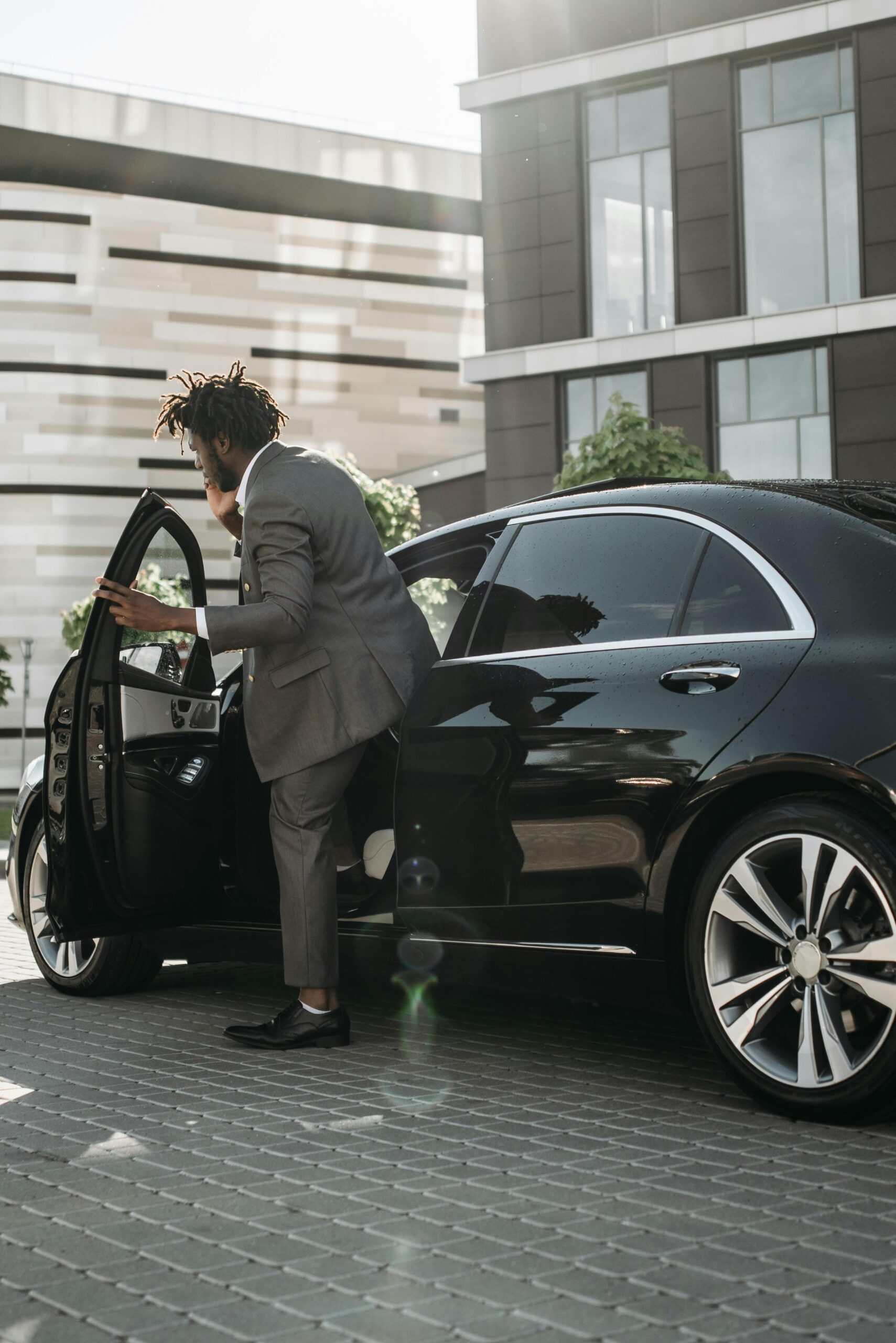Chauffeur loading luggage into an executive saloon